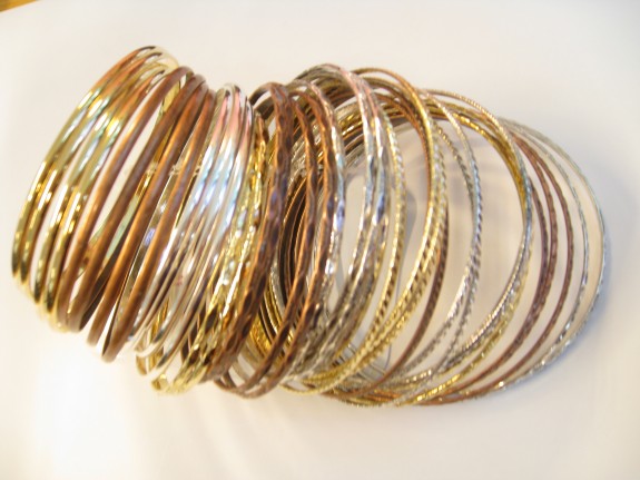 Gold, silver and bronze bracelets: Wear them all together, or choose a few to match with chunkier bangles for a more bohemian look.