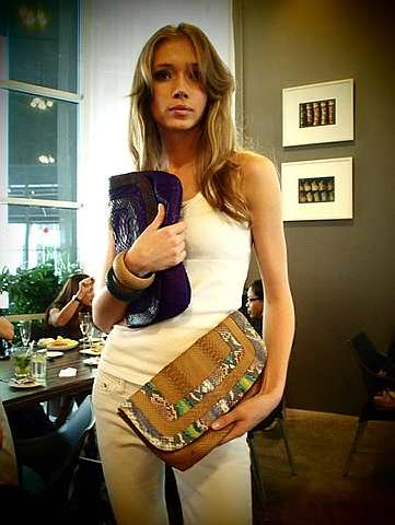 A model poses with clutches from Elaine Daly's new venture, Daly Bags.