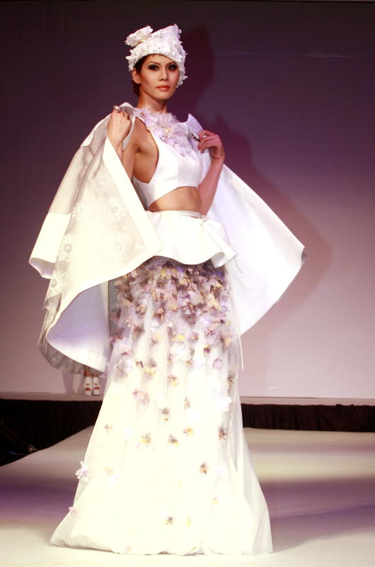 The winning team's cocktail attire saw the model putting on a convertible coat with white embellishments. 