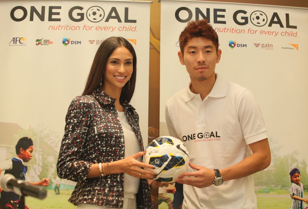 Ha Dae Sung presenting the autographed football to Deborah Henry