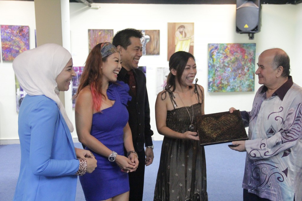 Alaa Bashiti, Lena Lim, Alvin Chan and Dymphna Lanjuran presenting an art piece titled "Colours Of Love" to Palestine ambassador Abdelaziz Abughoush during the Table 312 art exhibition.
