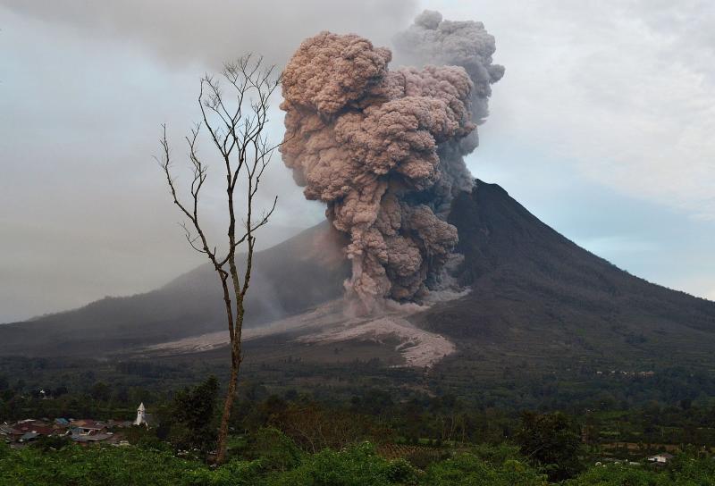 Mount Sinabung spewing ash into the air during an eruption.