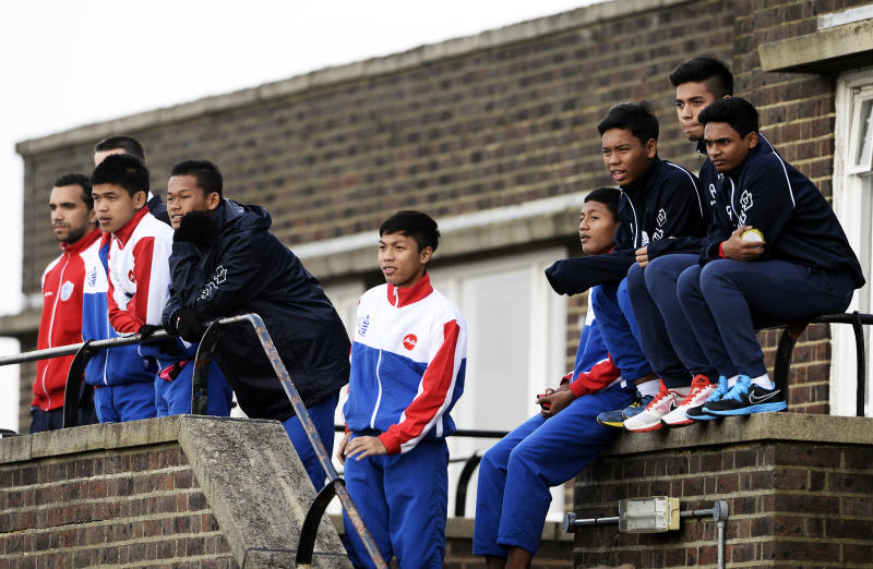 Future stars: The eight lucky youngsters who won the AirAsia QPR Coaching Clinic were sent to London to train at the QPR academy. They're pictured here observing QPR's first team, which includes stars like Joey Barton, Ravel Morrison, Jermaine Jenas and Richard Dunne, at the club's training ground.