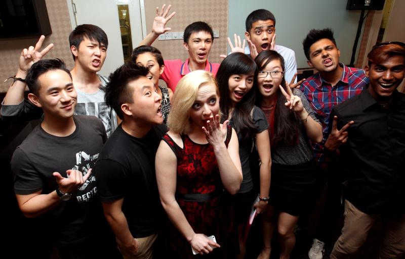 International YouTube stars (from left) Jason Chen, Jun Sung Ahn, David Choi, Kina Grannis (partially hidden) and Madilyn Bailey posing for a photo with some fans ahead of iM4U's Reach Out 2014 volunteerism convention.