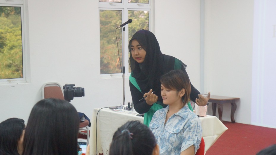 A representative from Mary Kay Cosmetics giving participants some makeup tips.