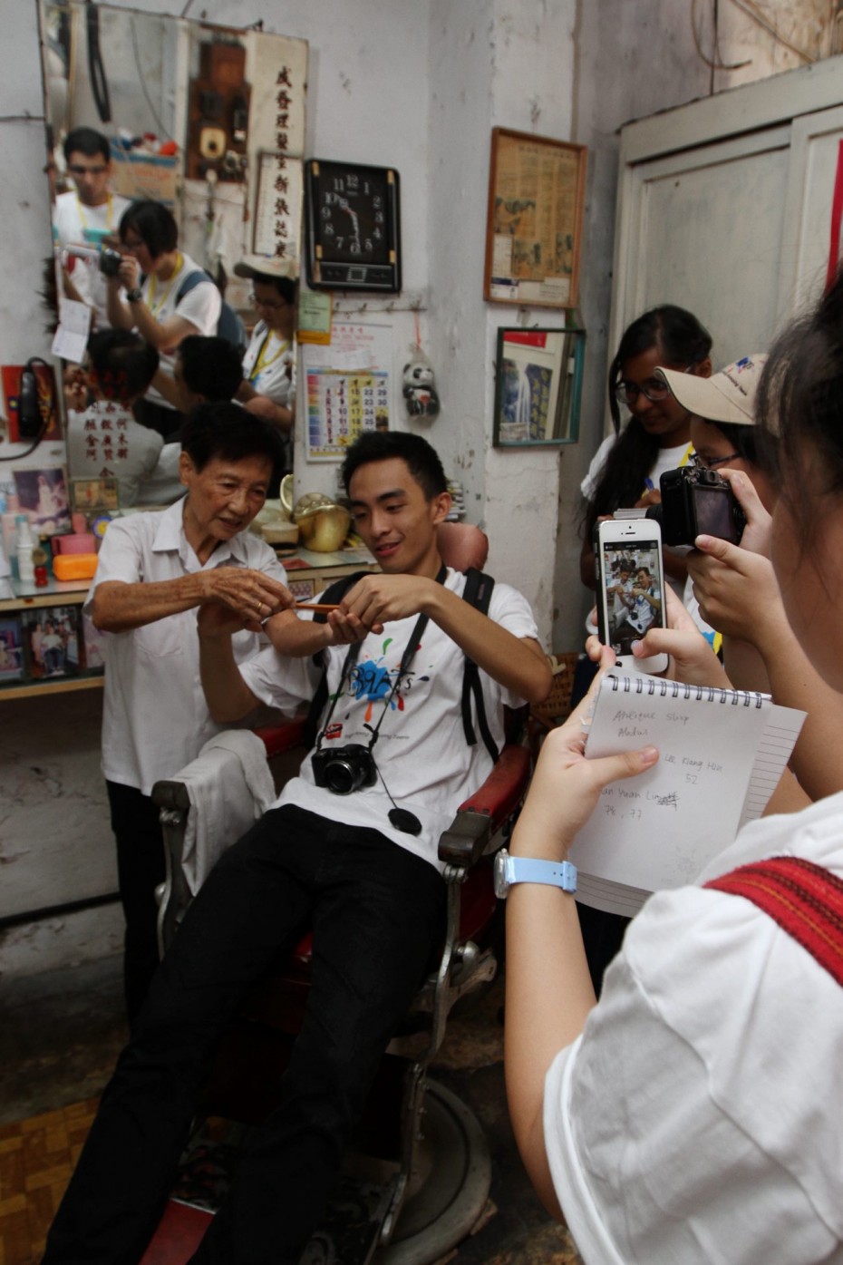 Human history: The BRATs interviewing Soo Xiu Keng, 78, who has run her own tiny barbershop just off Jonker Street for the past 58 years. Soo even let some of the BRATs sit on her barber's chair, which is over 100 years old! Photos by SAMUEL ONG/The Star