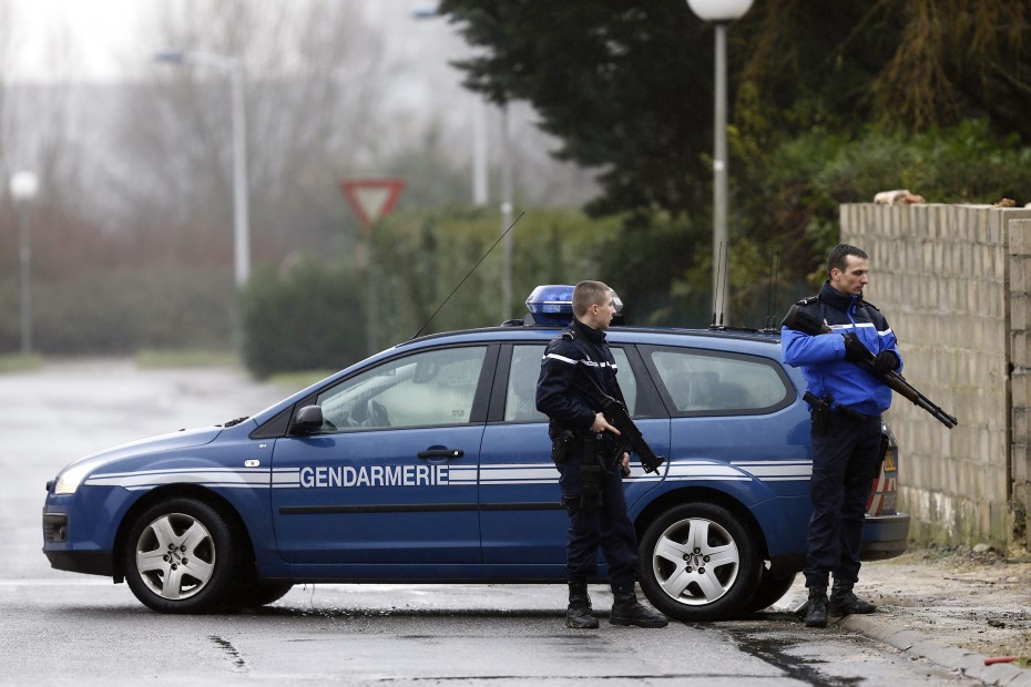 Police officers creating a security zone around the industrial area in Dammartin-en-Goele, where the two suspects are currently holding at least one hostage. -- Photo by EPA
