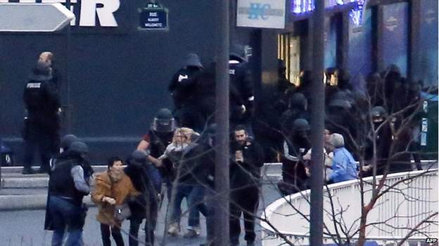 Picture of French police special forces escorting hostages out of the kosher supermarket in Porte de Vincennes. -- Photo by BBC