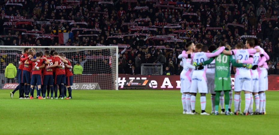 At the football match between French clubs Evian and Lille, where a minute's silence was observed. -- Photo by AFP