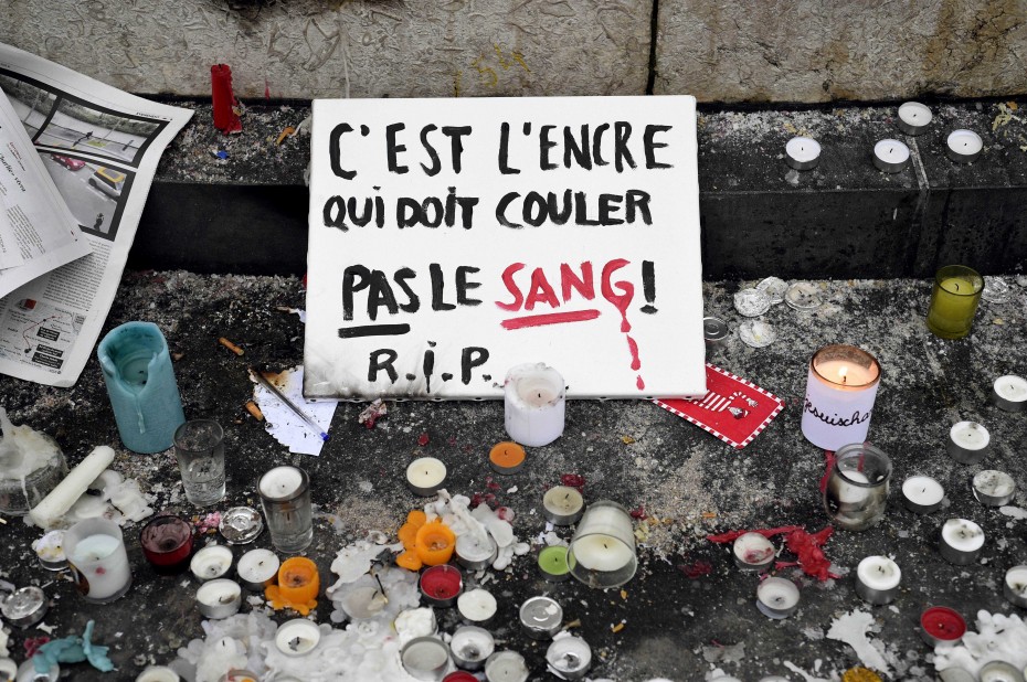 "It's ink that should flow not blood!" A sign at the centre of the Place de la Republique. -- Photo by AFP