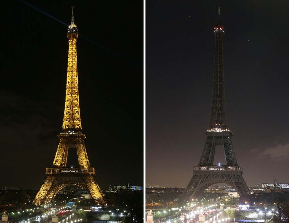 Paris' Eiffel Tower plunged into darkness at 8pm local time in honour of the victims. -- Photo by AFP