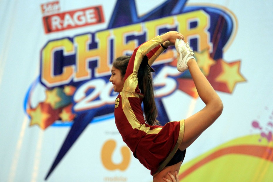 A Zelts cheerleader performing an elevated scorpion stunt at CHEER 2015. The Zelts are the cheerleading club of Seri Emas International School, and they sent three teams to compete at the CHEER 2015 Finals.