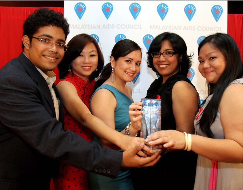 (Right to left) Goh, Sharmila, Nasa, Ivy Soon, and Qishin Tariq, receiving the Outstanding Achievement in Print Media award during the Red Ribbon Media Awards ceremony in 2012. — MOHD SAHAR MISNI/The Star