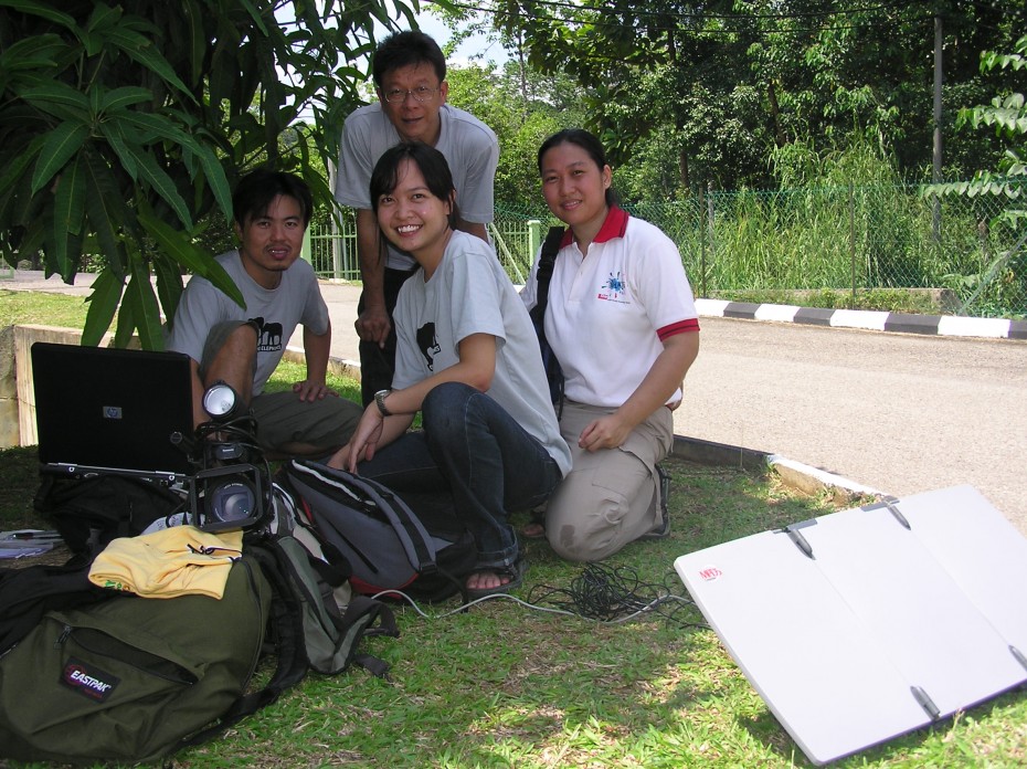 Yam (front) and (clockwise from left) Star photographers Darran Tan and Chua Kok Hwa, and Star marketing executive Nurmalis Abas using a satellite device to send their stories and photos. They were at a BRATs camp on elephant conservation at Kuala Gandah, Pahang.